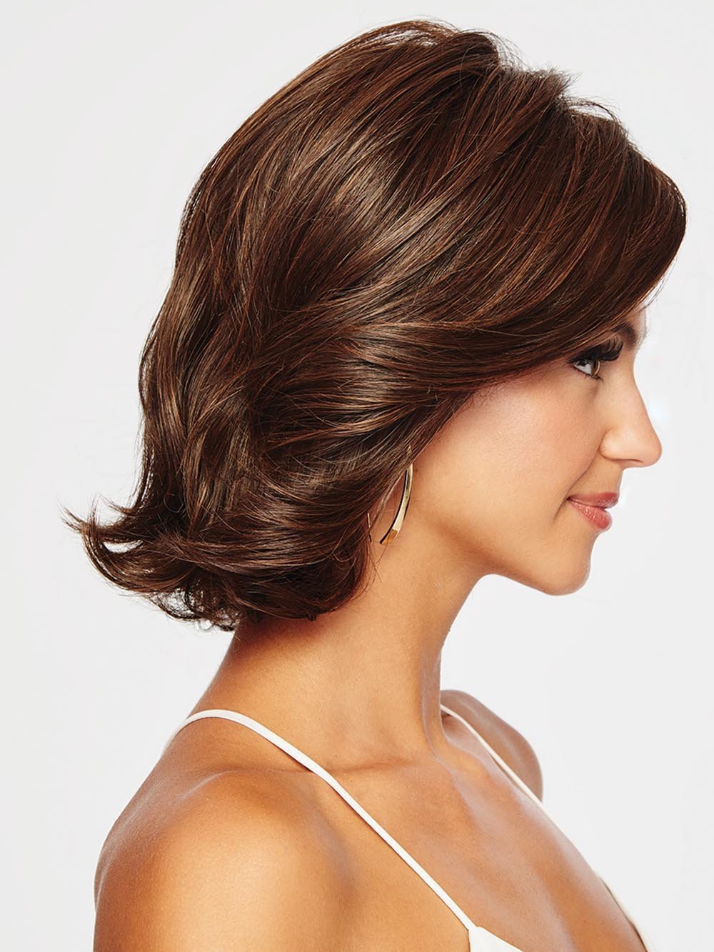 CROWD PLEASER has dramatic side swept bangs and long, subtle layering throughout.