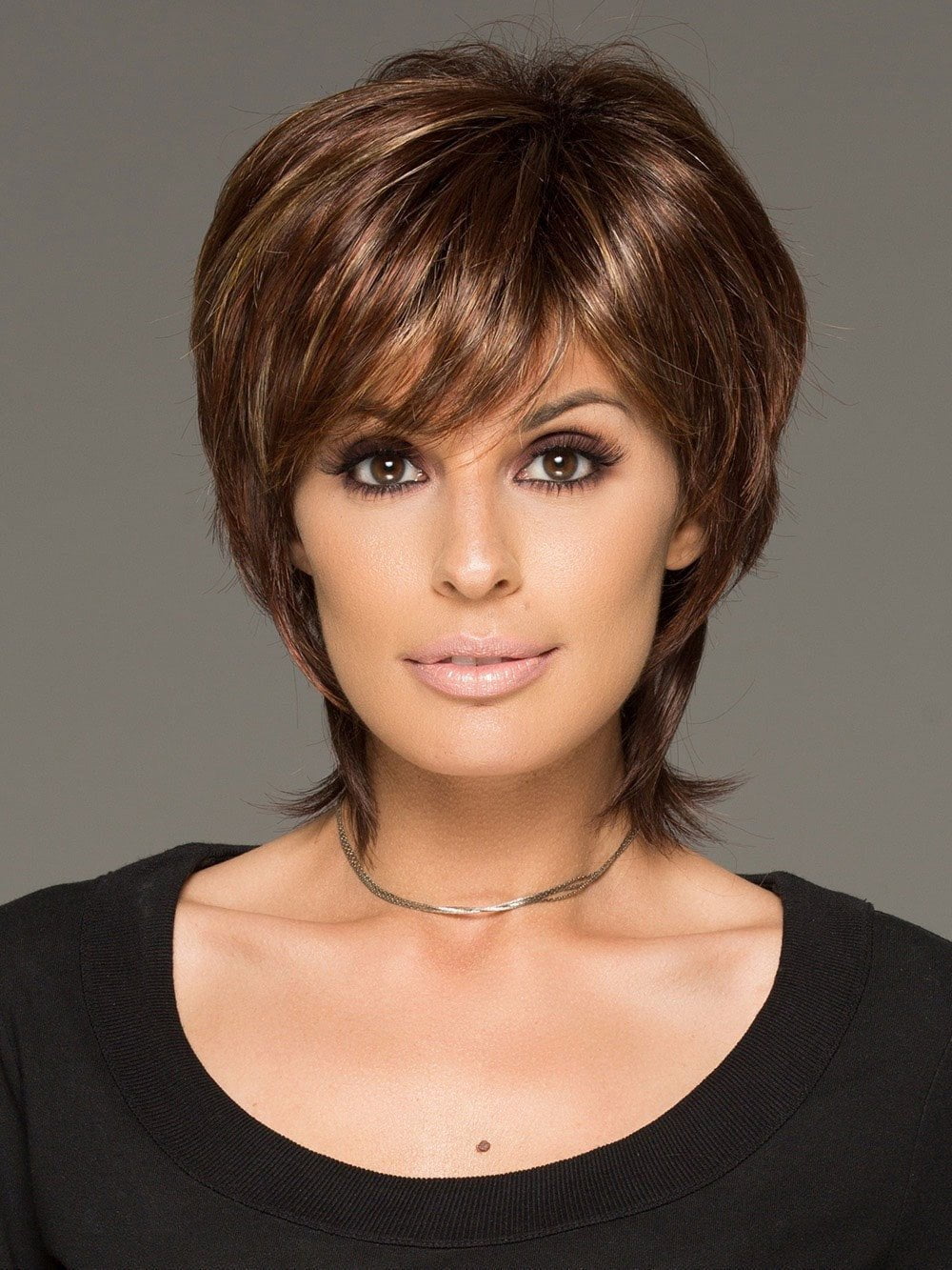 This tousled short wig has gorgeous layers and a long wispy nape for a new trend in today's fashion forward looks