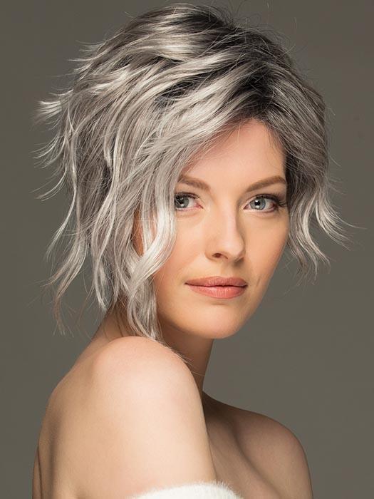 Ryan is a soft asymmetrical pixie style with long side-swept wavy bangs